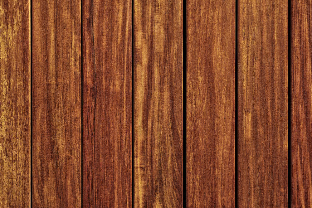 Close-up of Indonesian teak surface showing straight grain and rich natural oils.